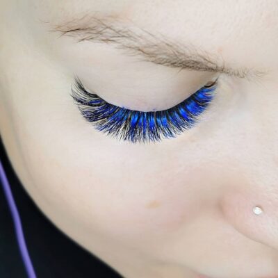 cobalt blue colored lashes woman applying eyelash extensions 