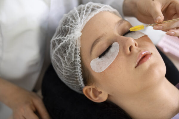 High angle woman wearing eye patches for eyelash extensions. LavisLash US