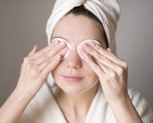 Woman using cotton pads to clean her eyes. DIY lash extensions. LavisLash US